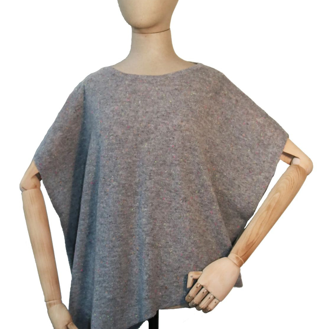 A heather gray knit poncho sweater displayed on a wooden mannequin torso against a plain white background.