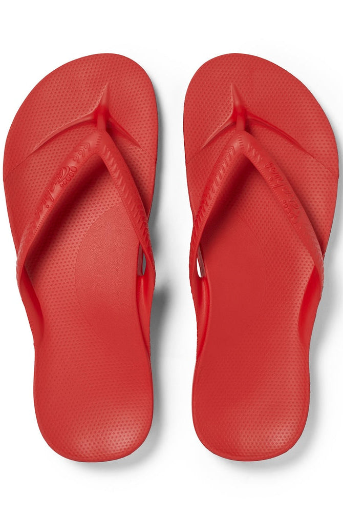 Pair of red flip-flops on a white background