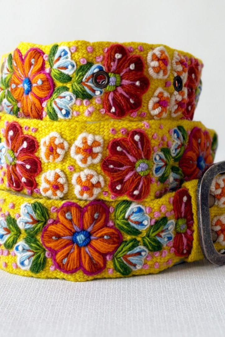 Colorful floral belt with a metal buckle on a white background