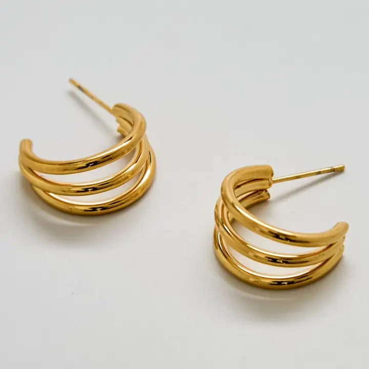 Gold triple arc hoop earrings on a white background