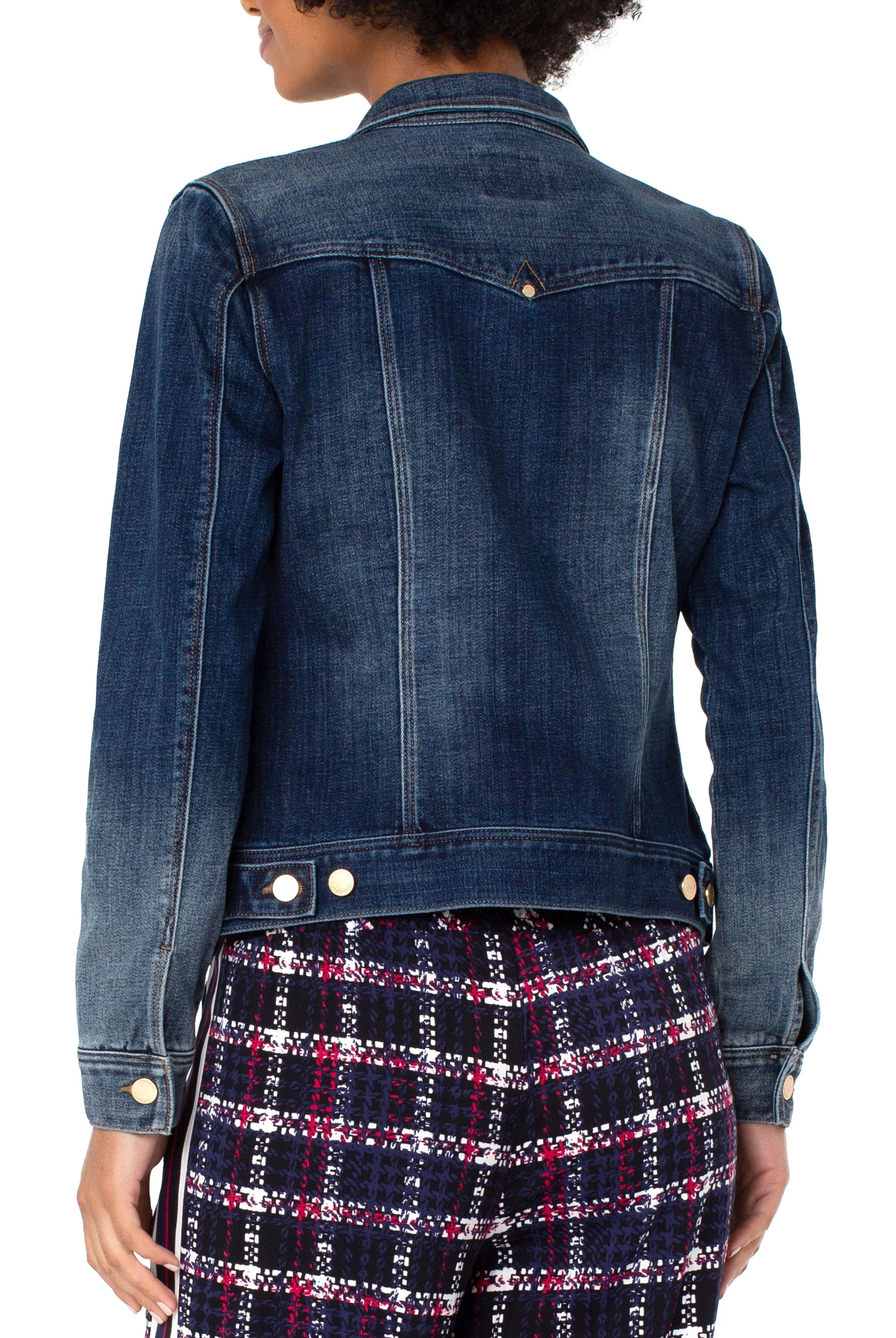 Denim jacket worn by a person on a white background