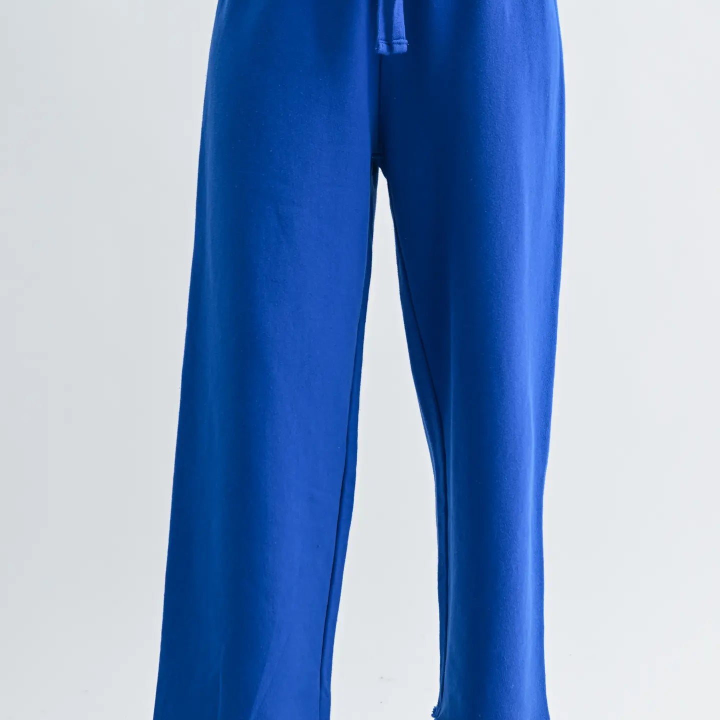 Blue pants worn by a person on a white background