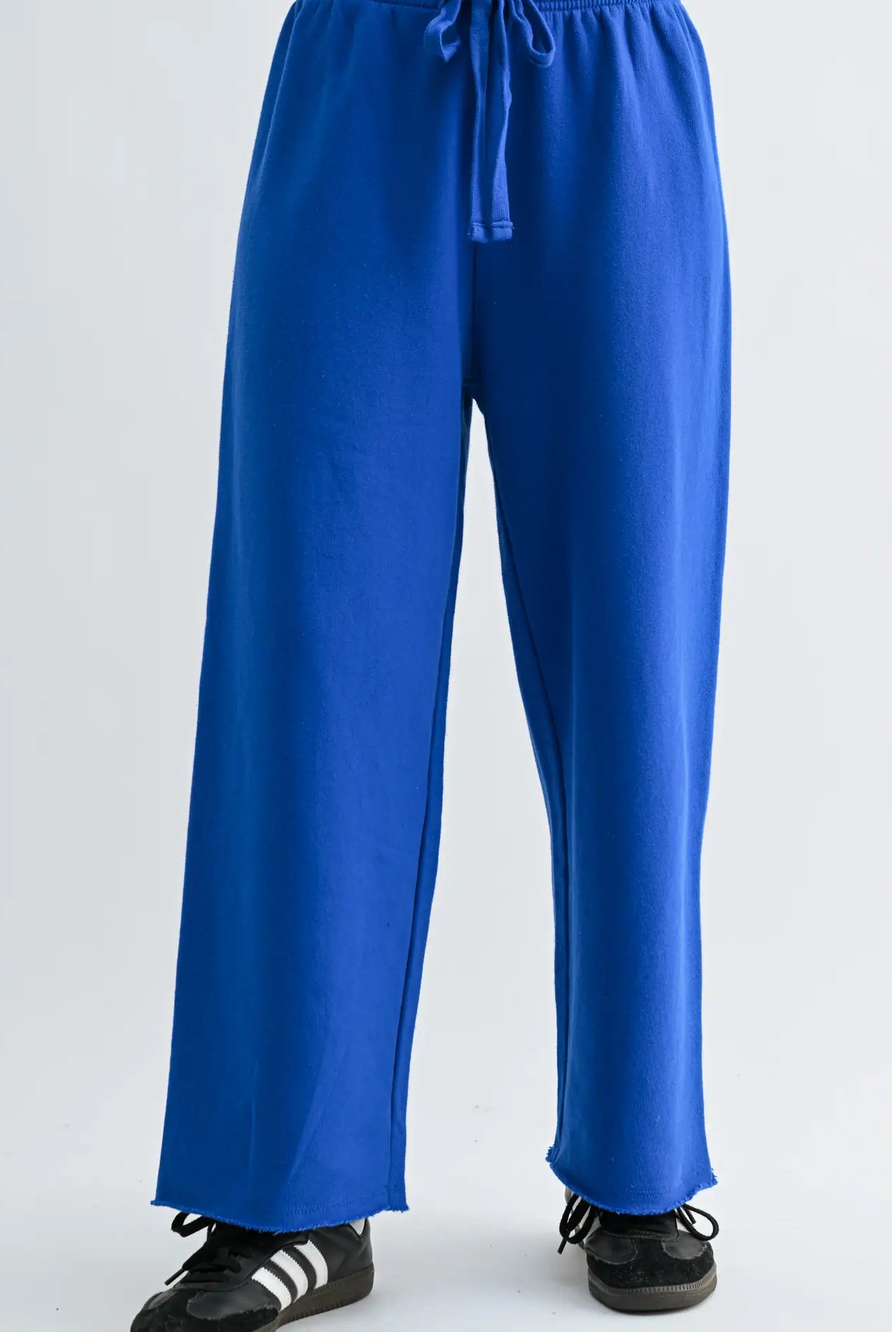 Blue pants worn by a person on a white background