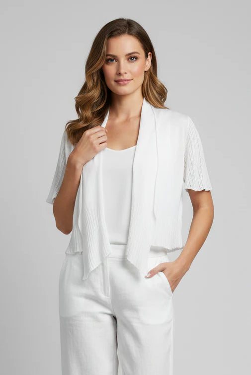 Woman wearing a white outfit with a light gray background
