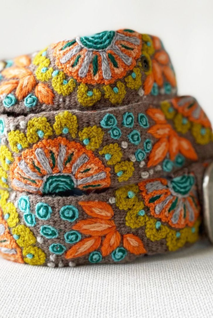 Decorative belt with floral patterns on a grey background