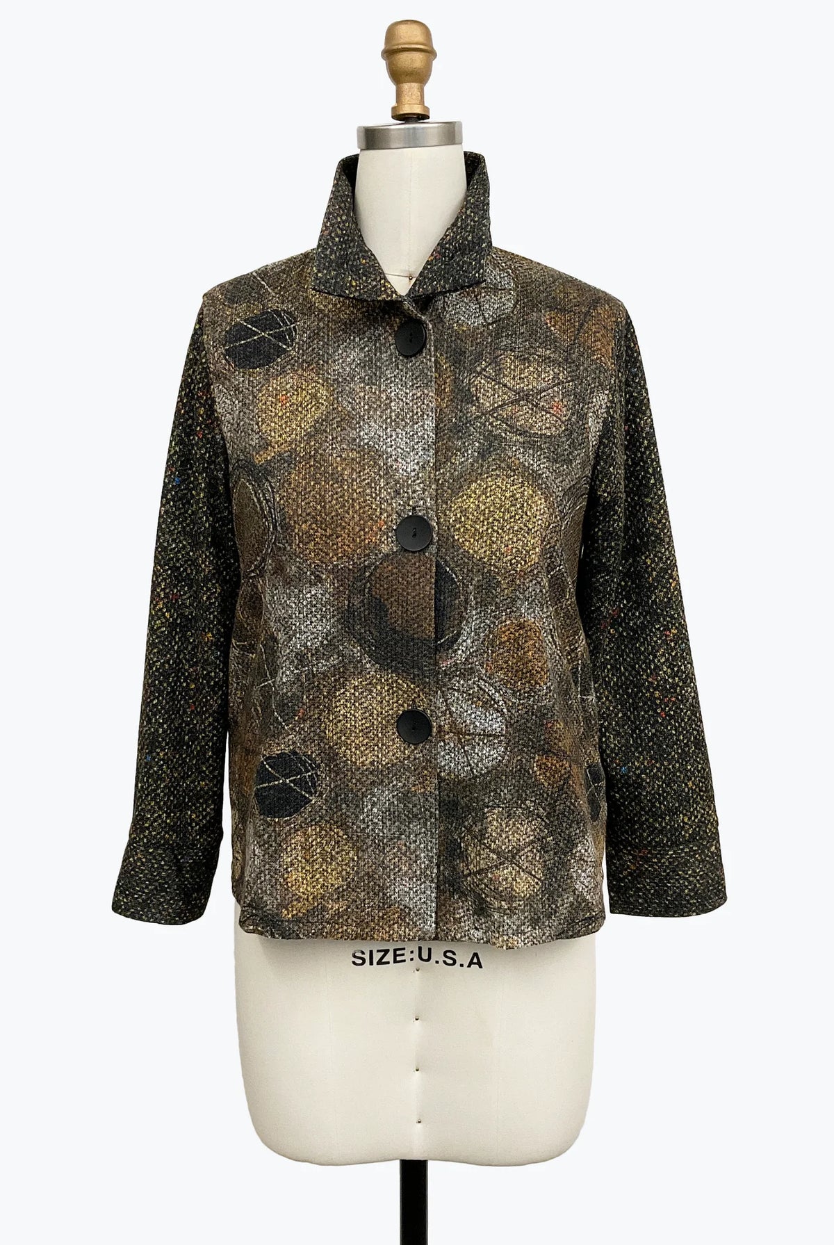 A women's long-sleeve button-front jacket displayed on a cream dress form mannequin. The jacket features a mixed abstract pattern with snakeskin-style brown and black patterns on the front panel and a solid black textured fabric on the sleeves.