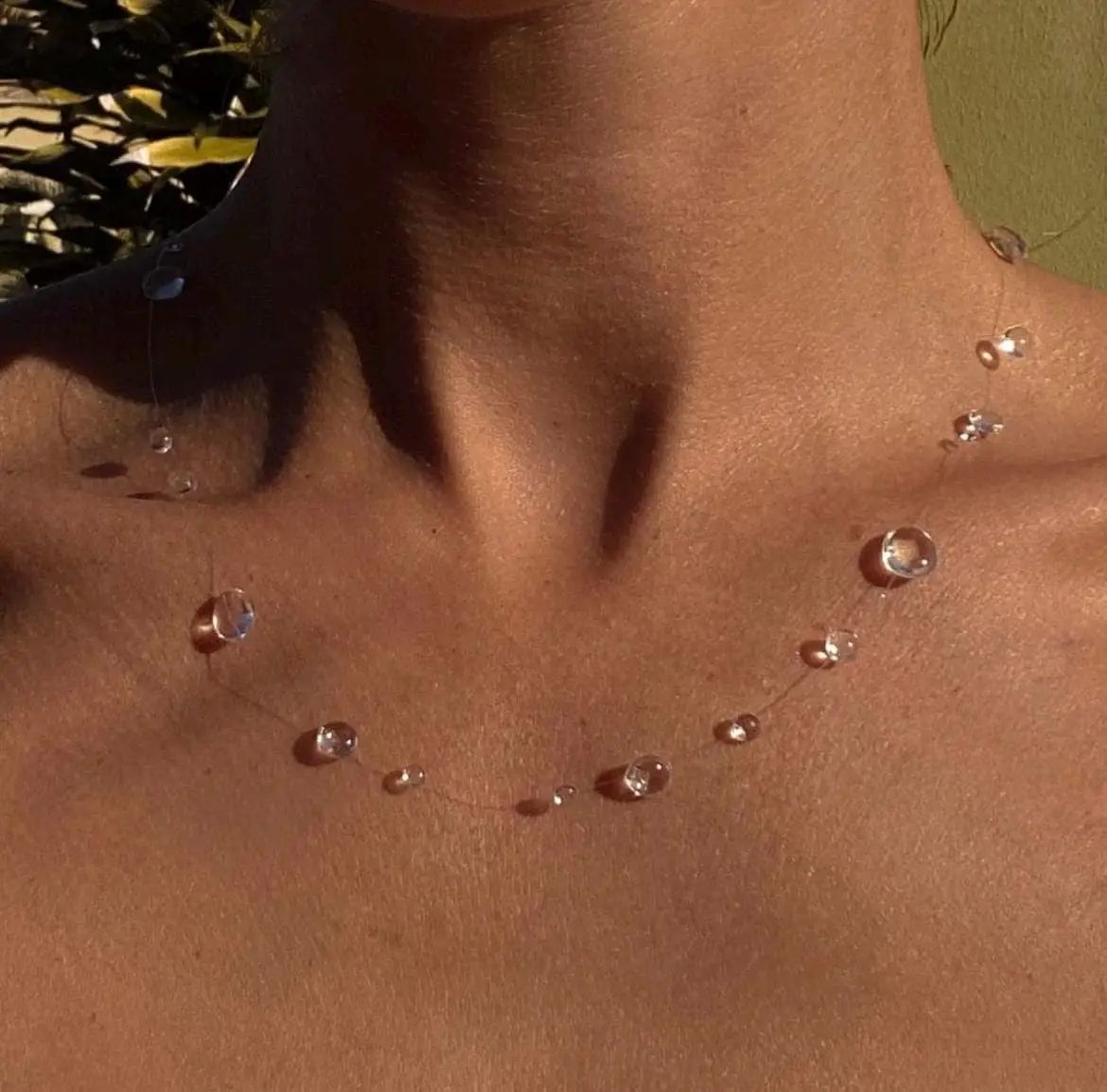 Close-up of a person's neck with water droplets on skin