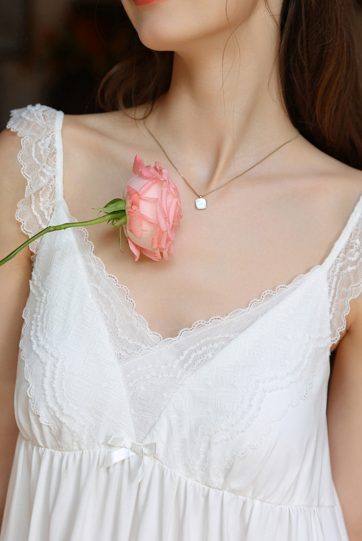 Lace straps and V-neckline on the white nightgown