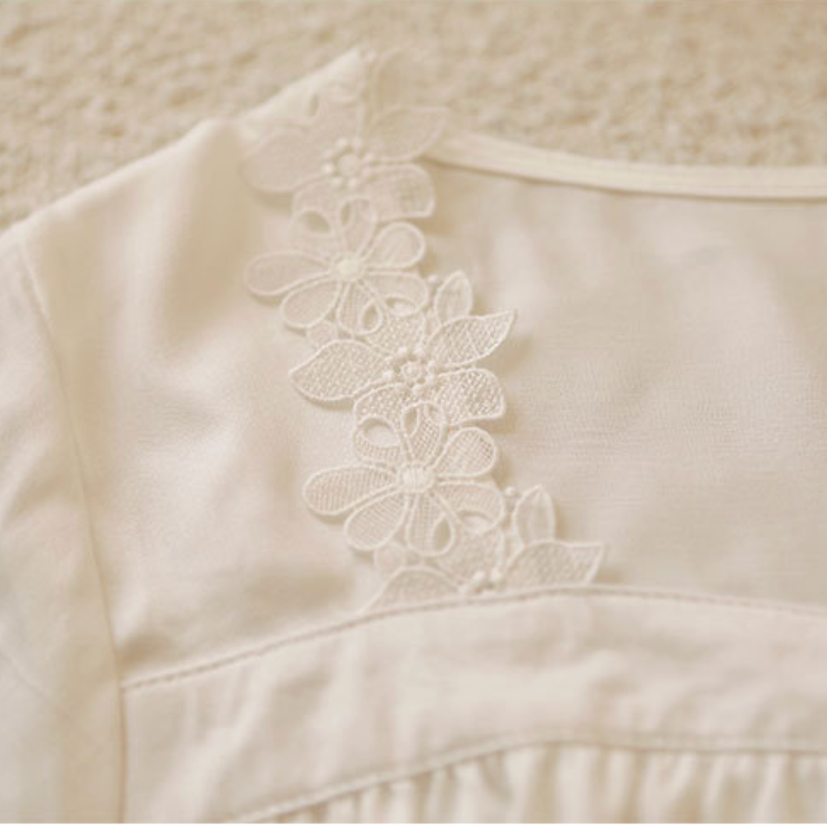 Close-up of the floral lace trim on the white viscose nightdress