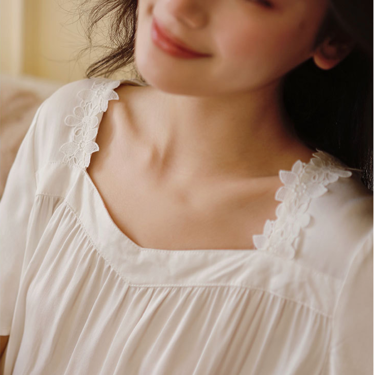 Floral lace detail on the square neckline of the white nightdress