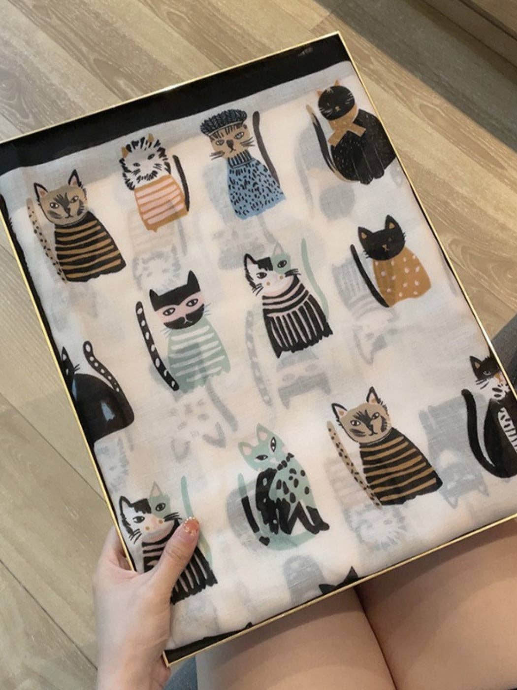 Cat print scarf laid flat showing the illustrated cats