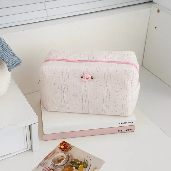 Textured cosmetic pouch with rose detail, alternate view