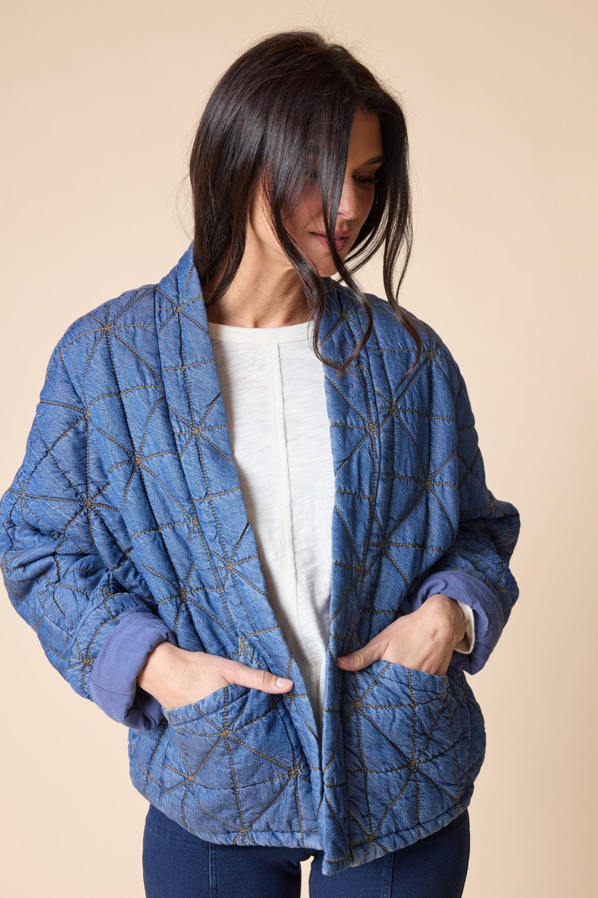 Habitat Diamond Quilt Kimono Jacket in medium denim with hands in patch pockets, three-quarter view