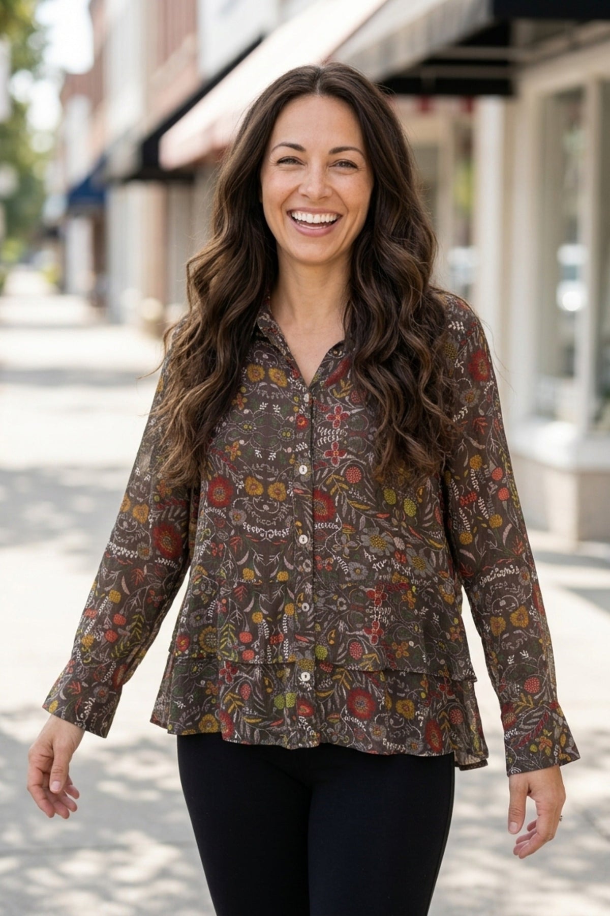Woman wearing the Habitat Rayon Crepe Garden Flounce Shirt in olive floral print with black pants