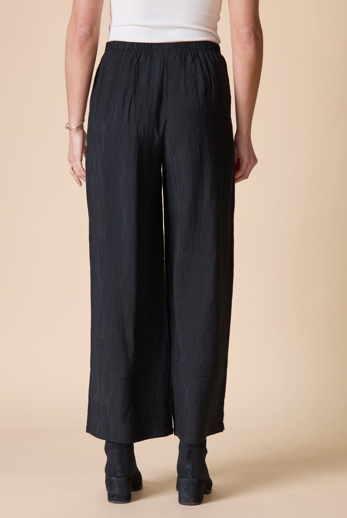Back view of the Habitat Rayon Jacquard Button Hem Pant in black wide leg