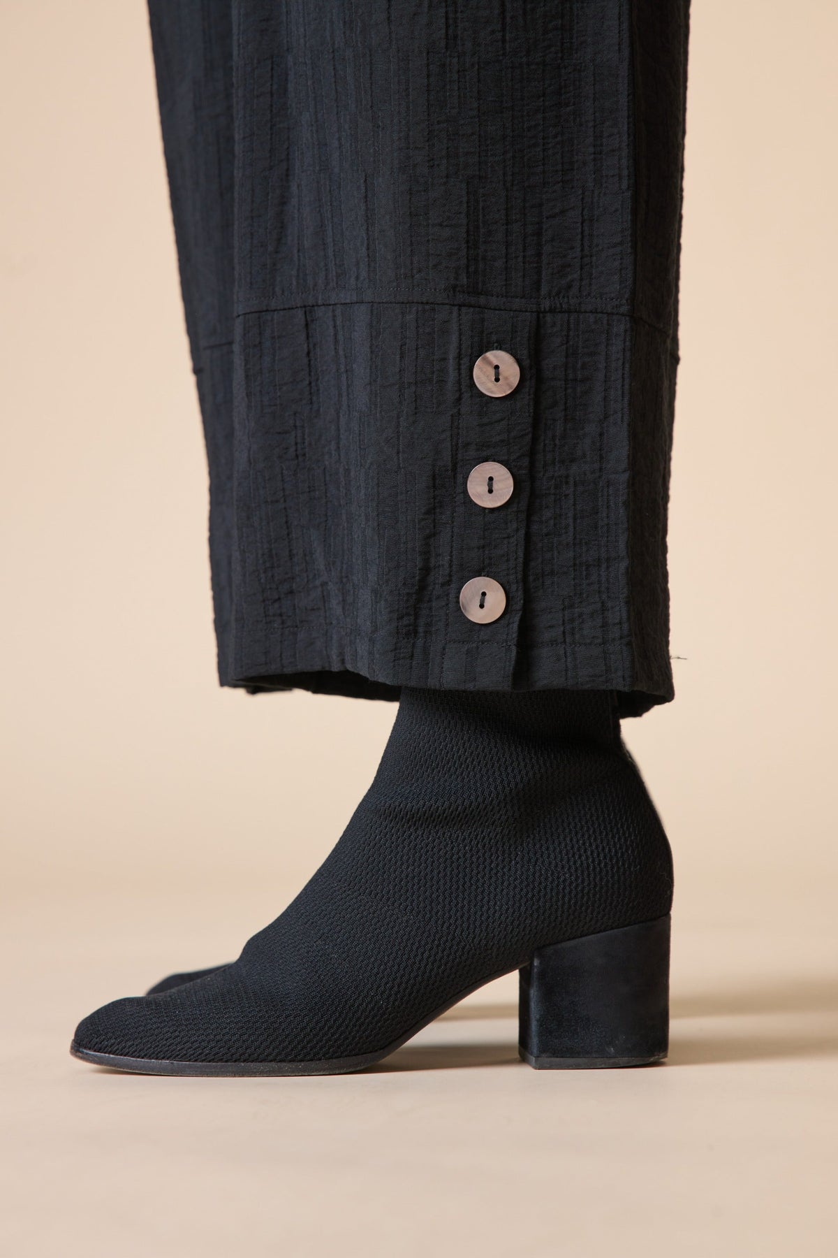 Close-up of the three-button hem on the Habitat Rayon Jacquard Button Hem Pant in black