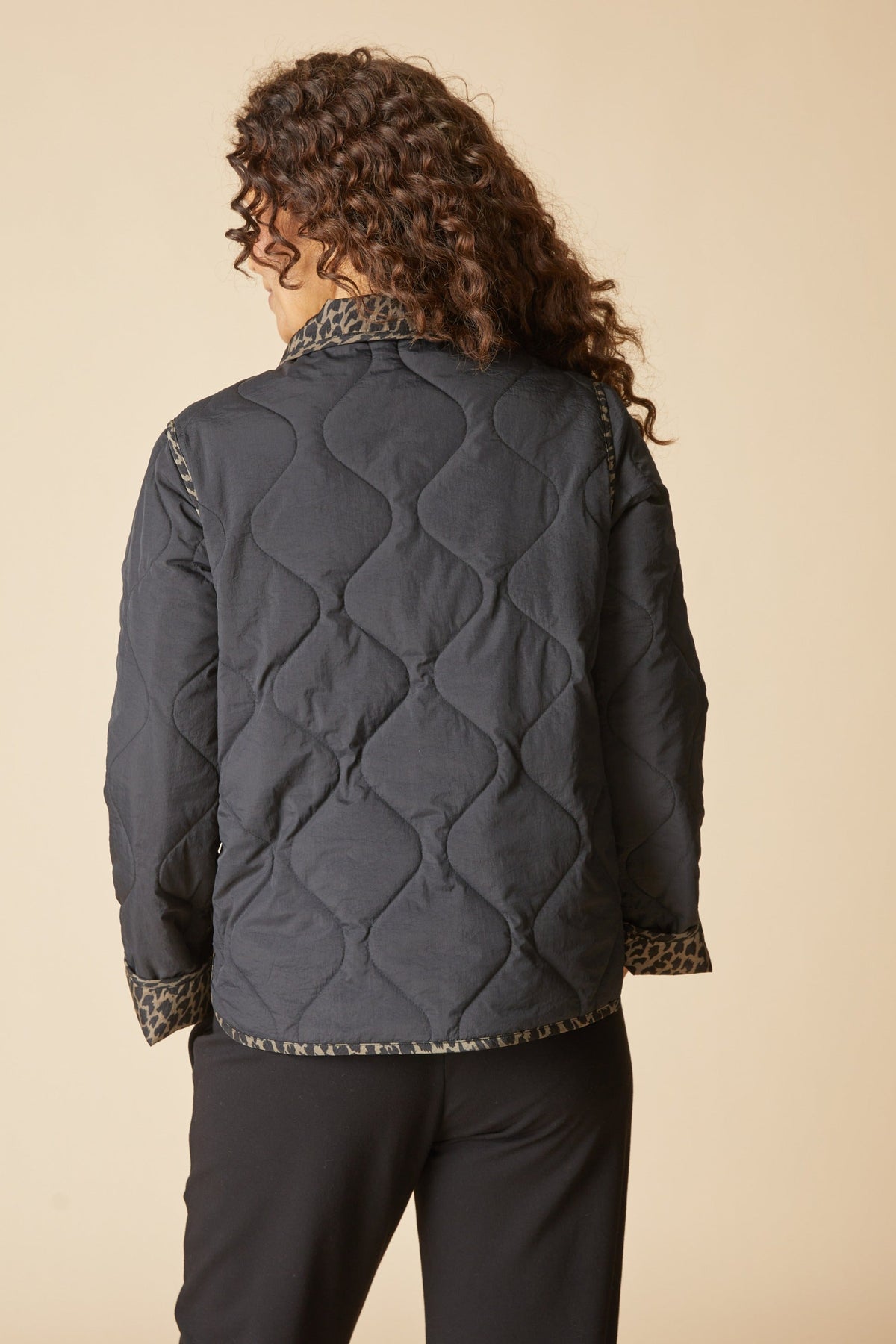 Back view of the Habitat Reversible Print Quilt Puffer Coat in black with wave quilting