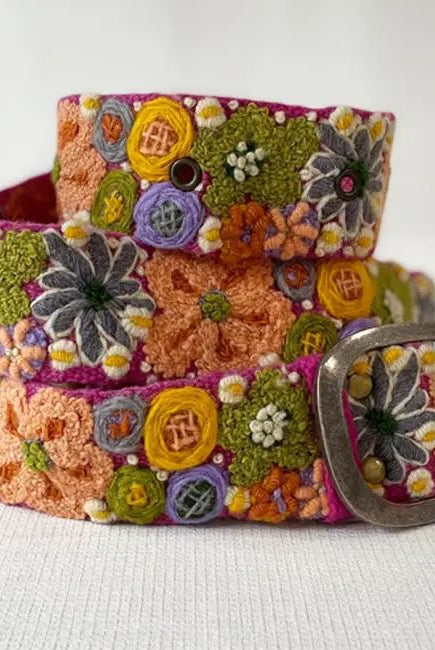 Colorful embroidered belt with floral patterns on a white background