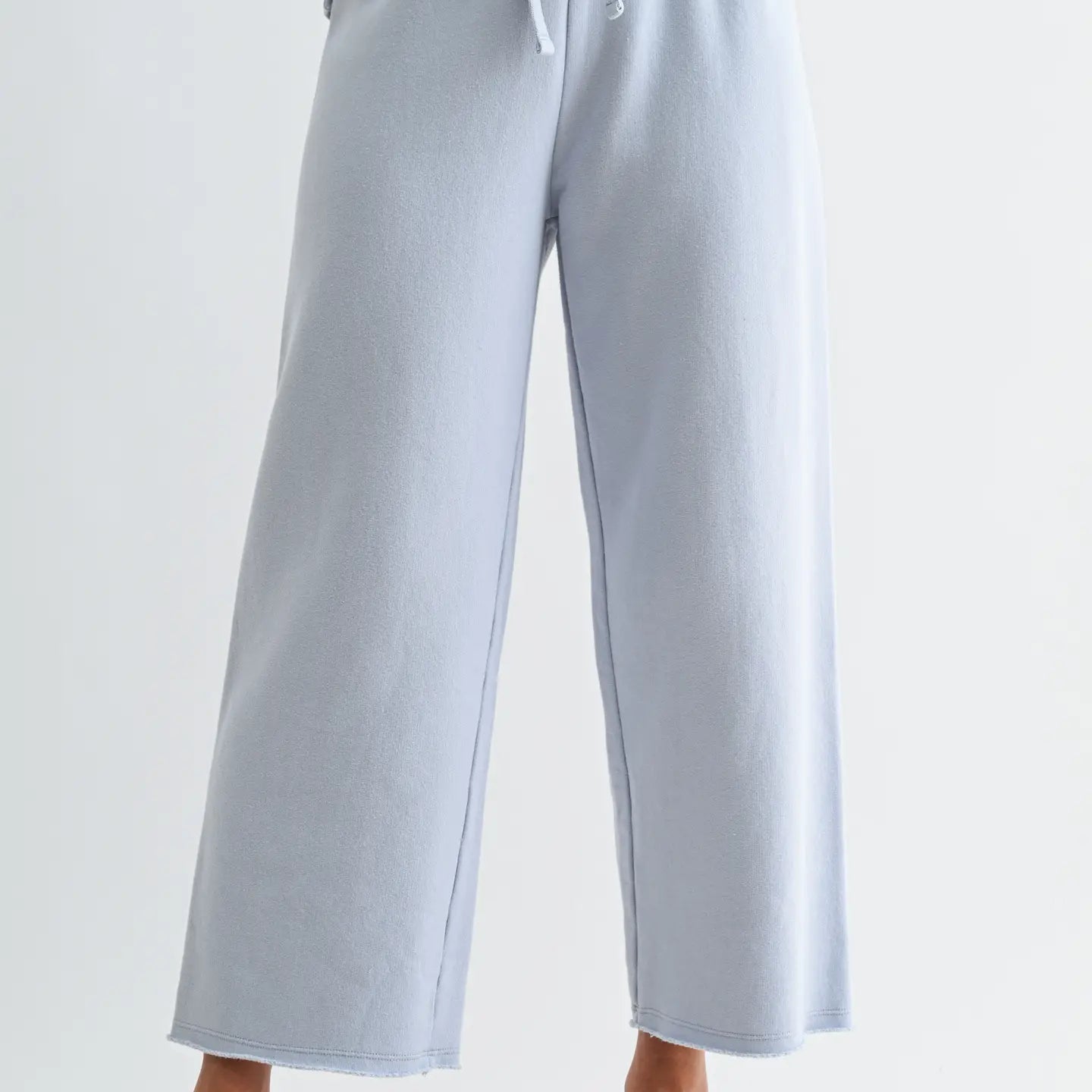 Light blue wide-leg pants worn by a person on a white background