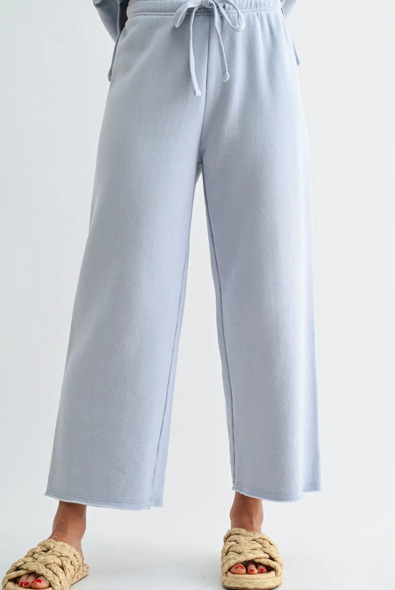 Light blue wide-leg pants worn by a person on a white background