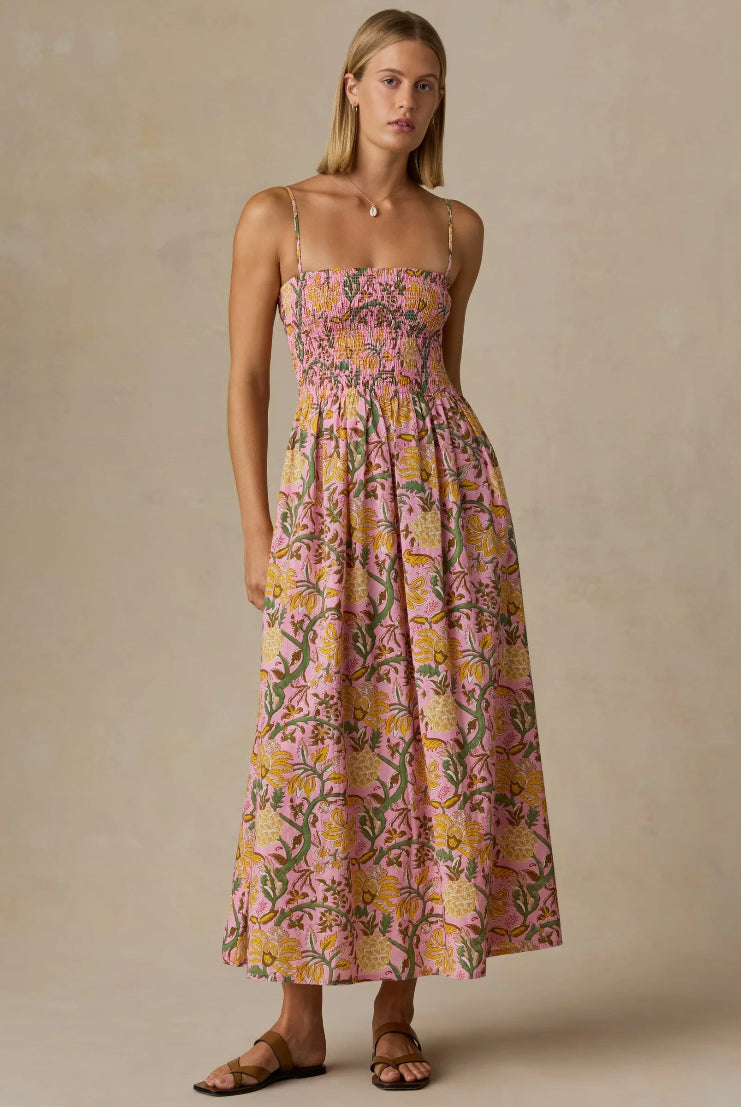 Woman wearing a floral dress against a beige background