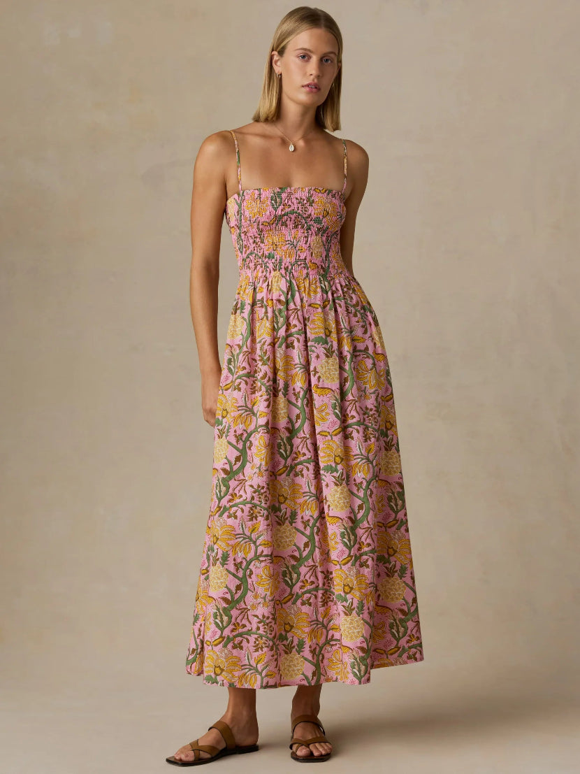 Woman wearing a floral dress against a beige background