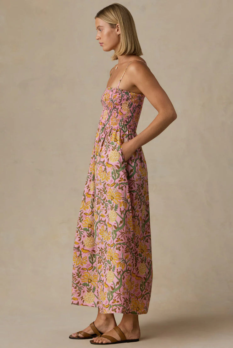 Woman wearing a floral dress against a beige background