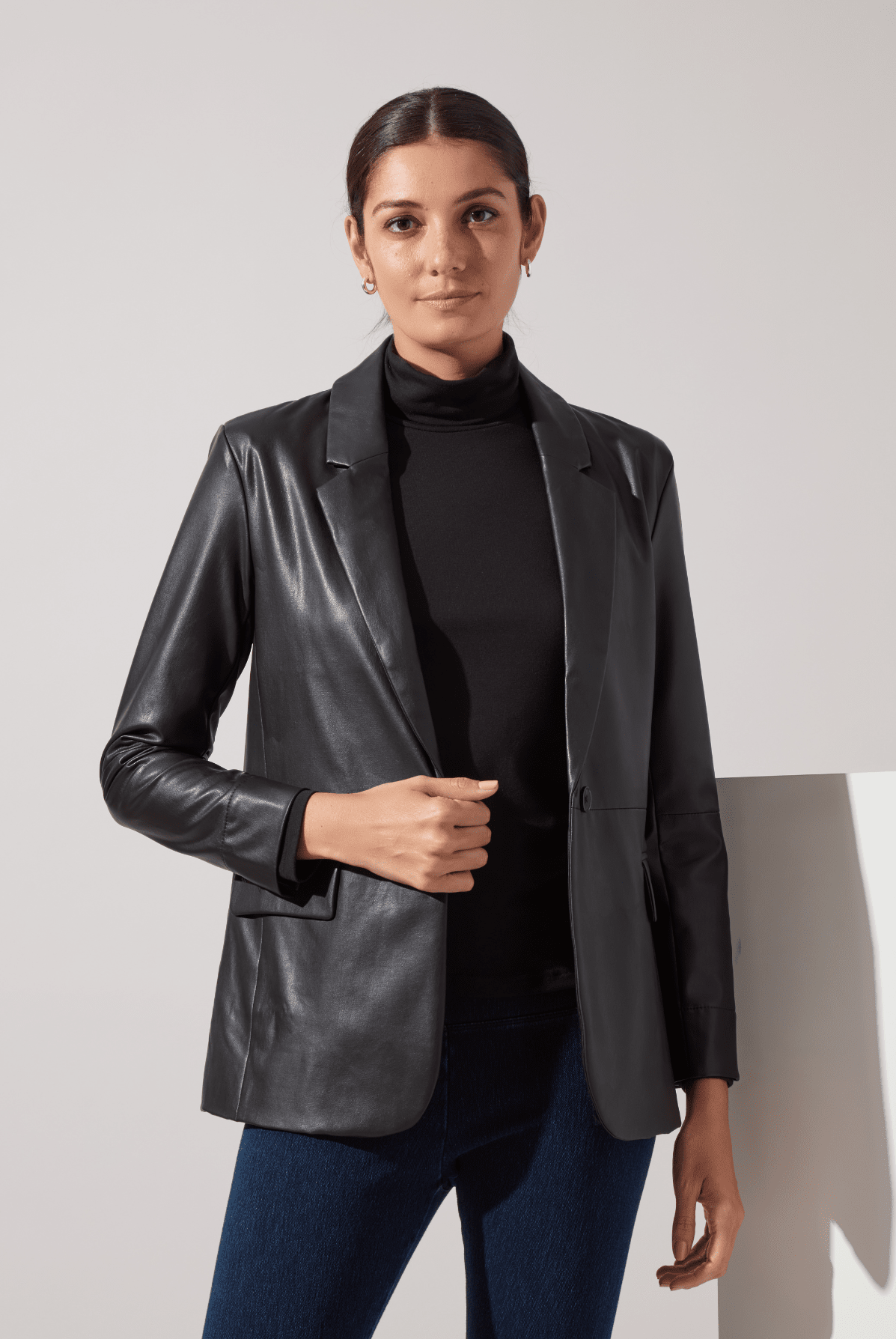Lysse Essential Longsleeve Turtleneck in Black, styled under a black leather blazer with jeans