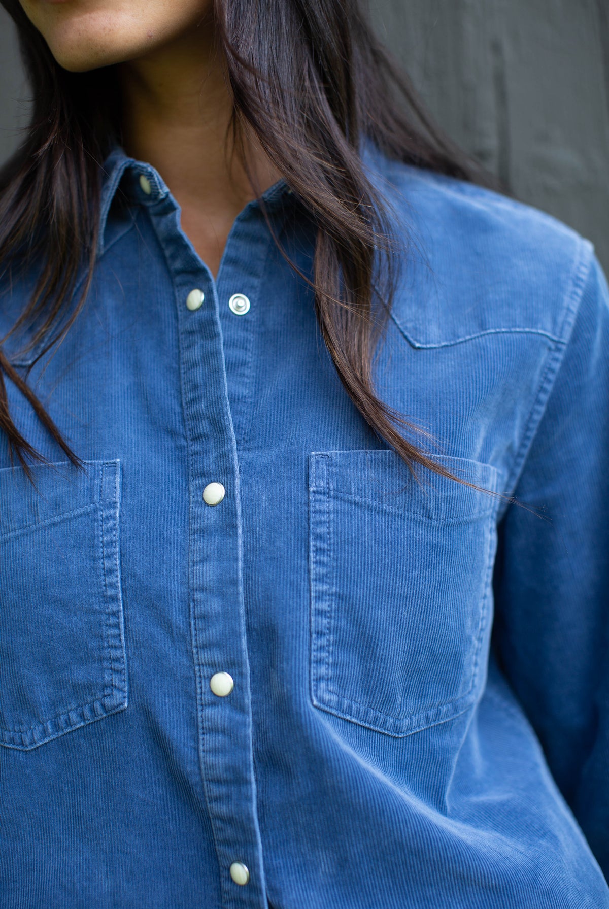 Close-up of the Marea Corduroy Western Shirt in Indigo showing the yoke, chest pockets and pearl snaps