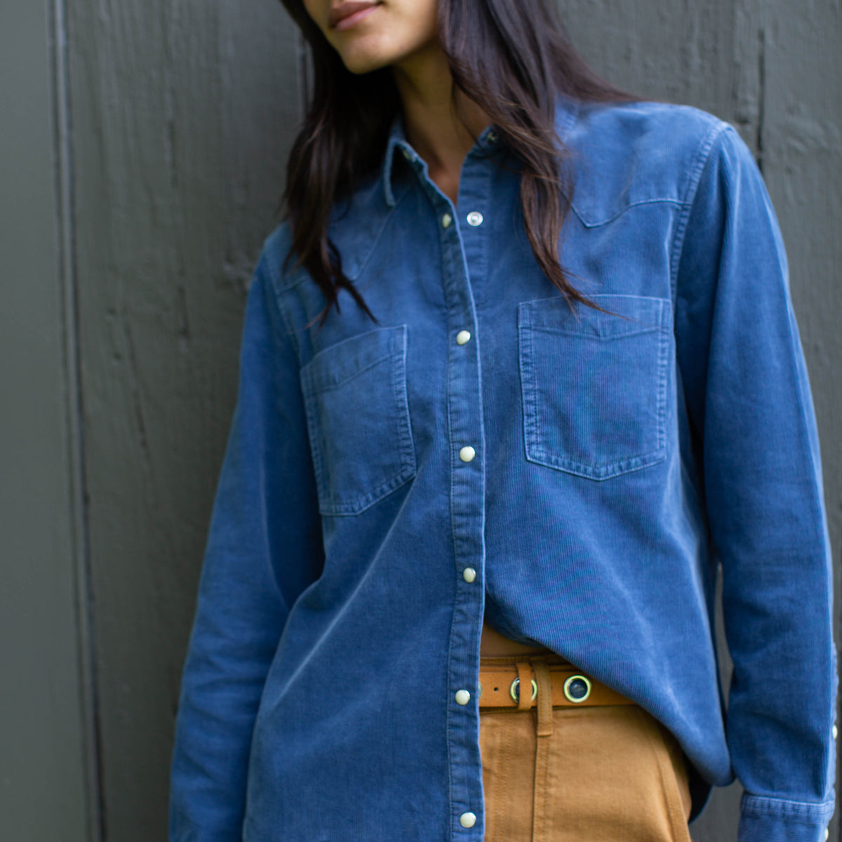 Marea Corduroy Western Shirt in Indigo with snap front, tucked into camel trousers