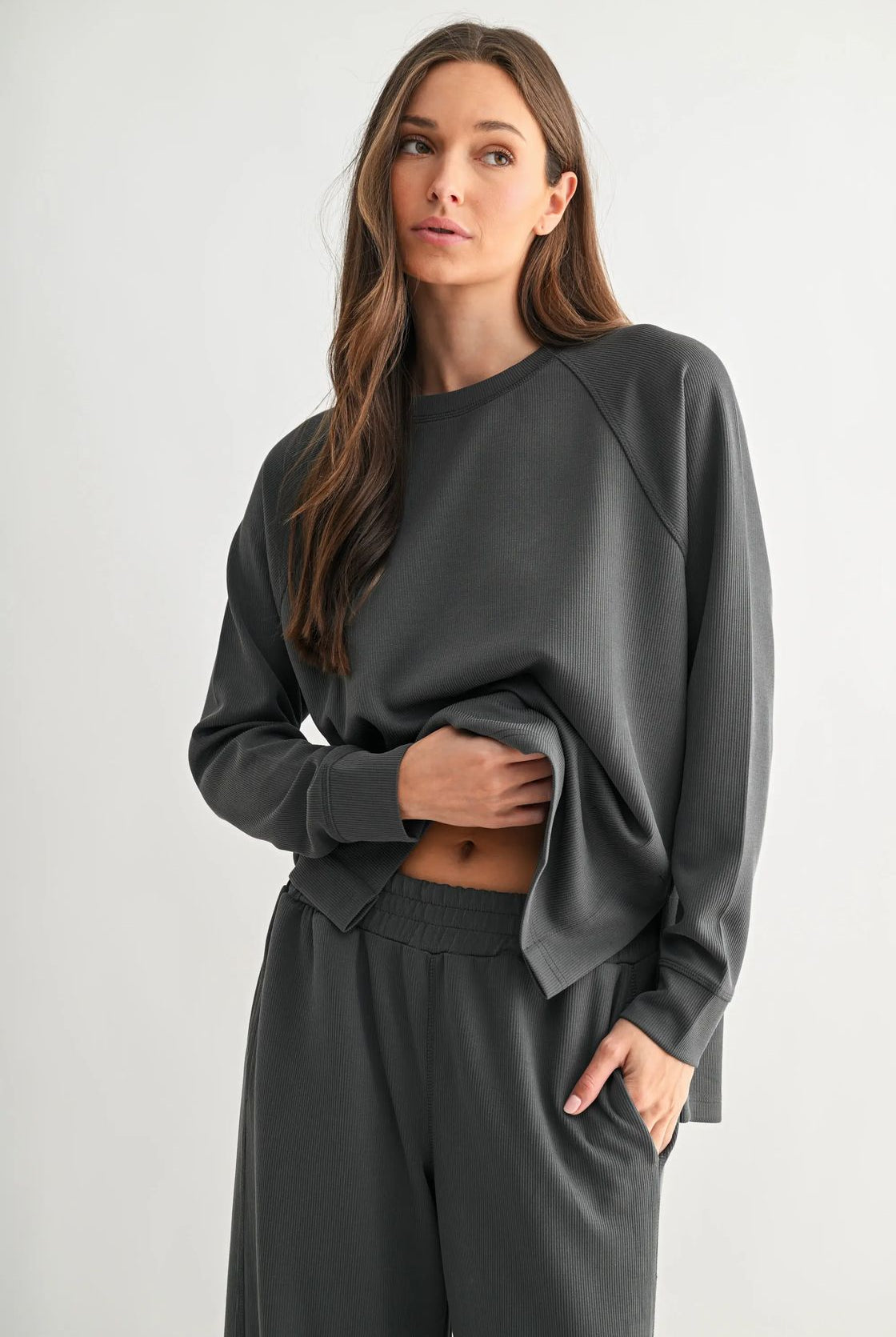 woman wearing ash grey matching top and pant with white background