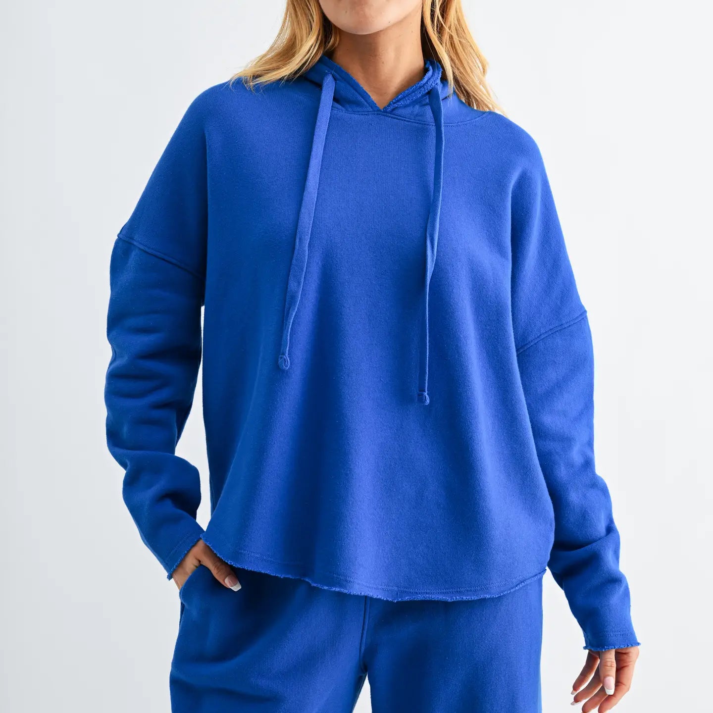 woman wearing bright blue hoodie and matching pants