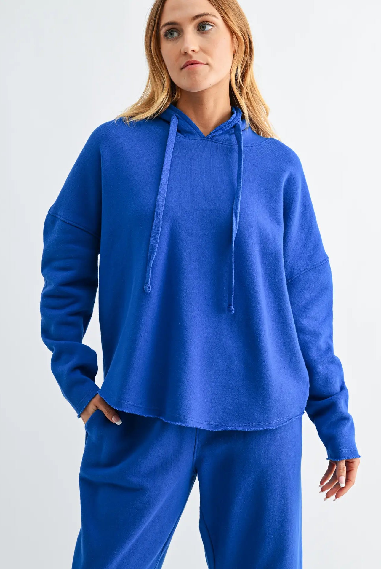 woman wearing bright blue hoodie and matching pants
