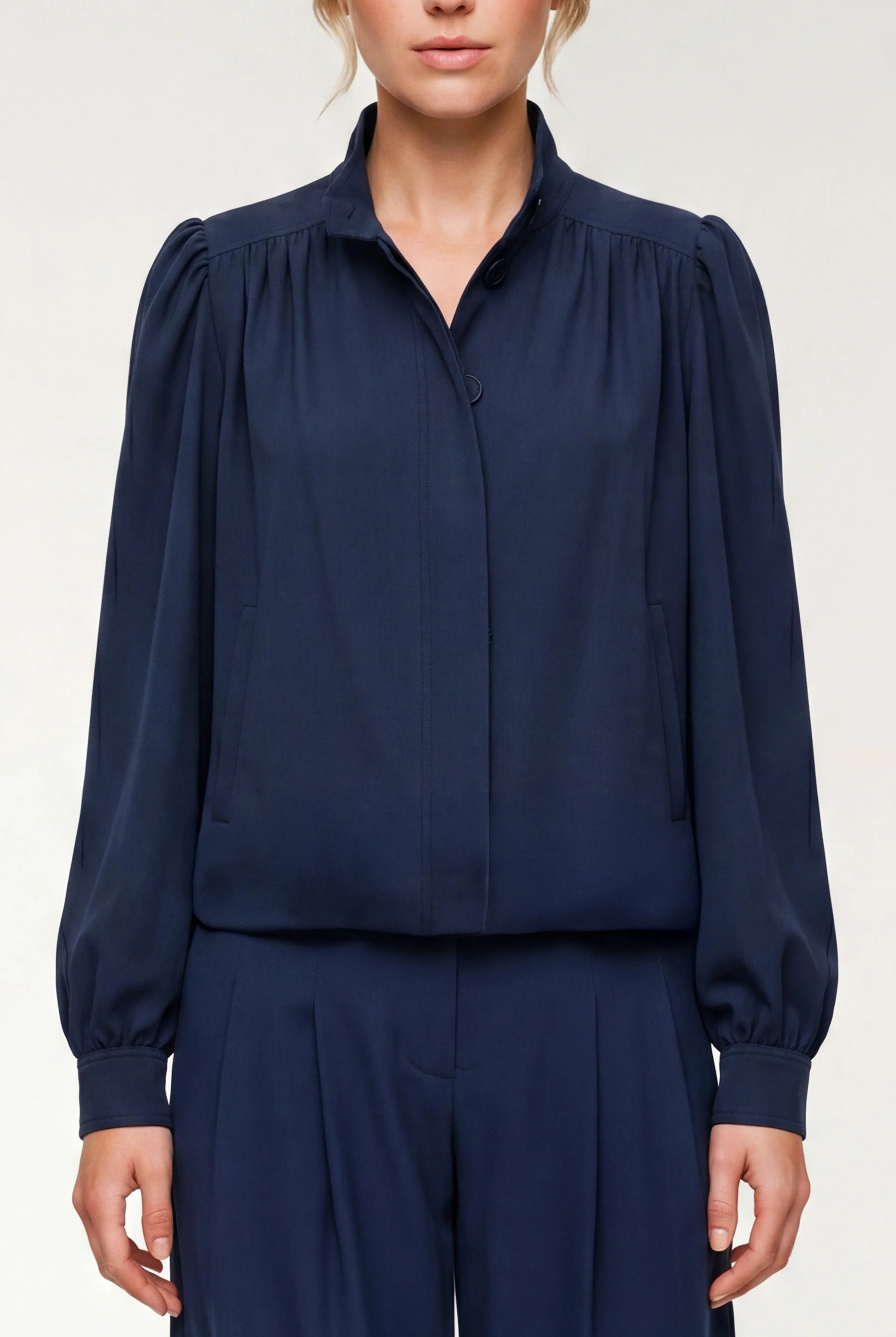 Navy blue blouse with long sleeves on a white background
