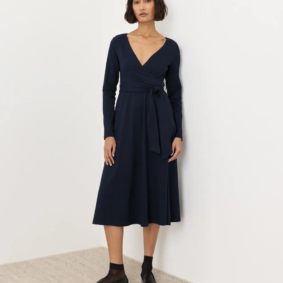 PACT Fit and Flare Wrap Dress in solid navy, long-sleeve V-neck wrap midi with self-tie waist, front view