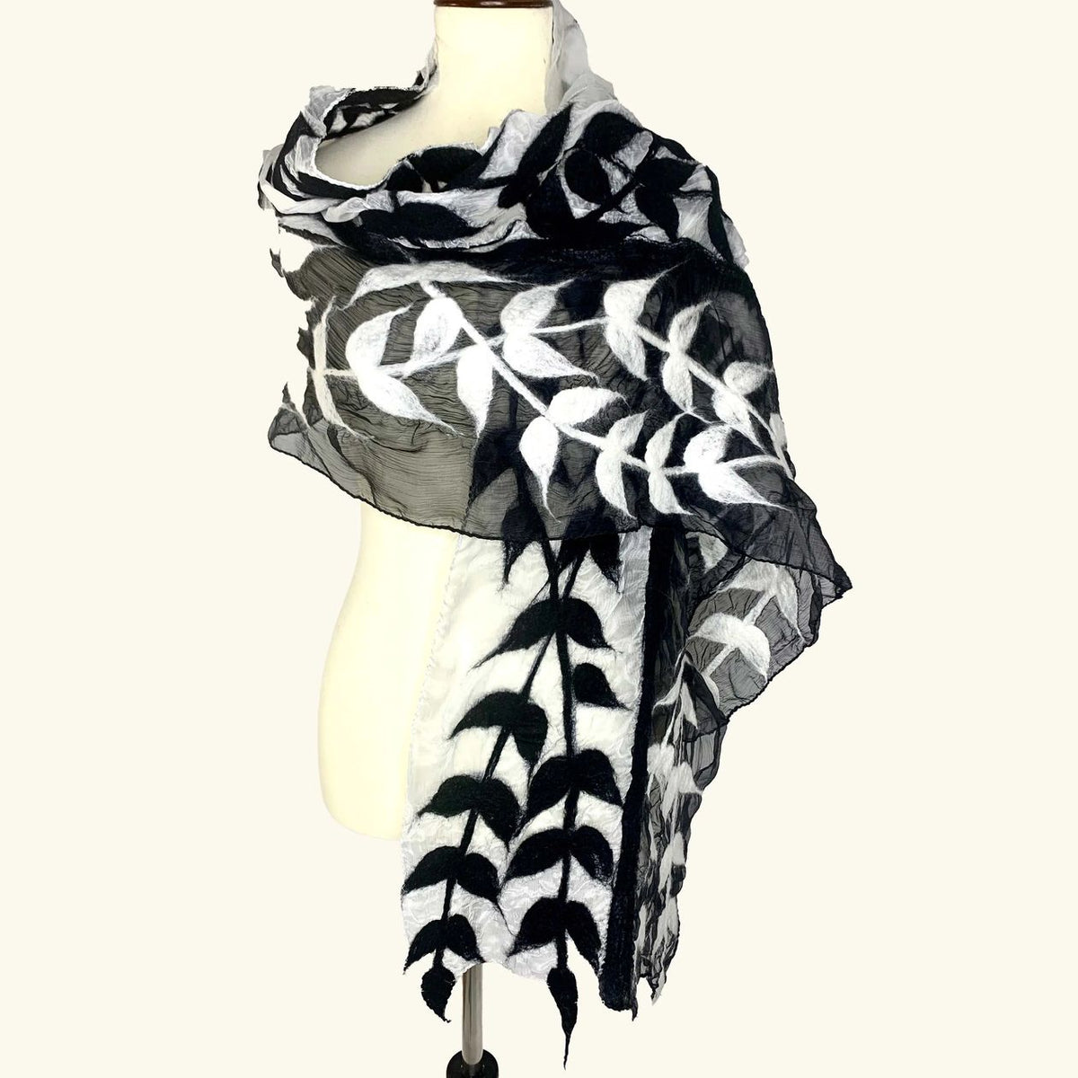 Pomegranate Moon Split Vine hand-felted silk and wool scarf with black and white vine leaves on gray, displayed on a dress form