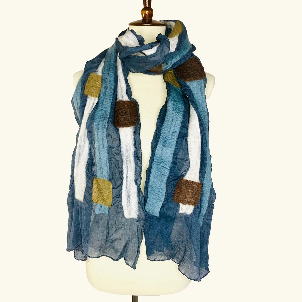 Pomegranate Moon Squares and Stripes hand-felted silk and wool scarf in blue and gray stripes with ivory and cocoa squares, displayed on a dress form
