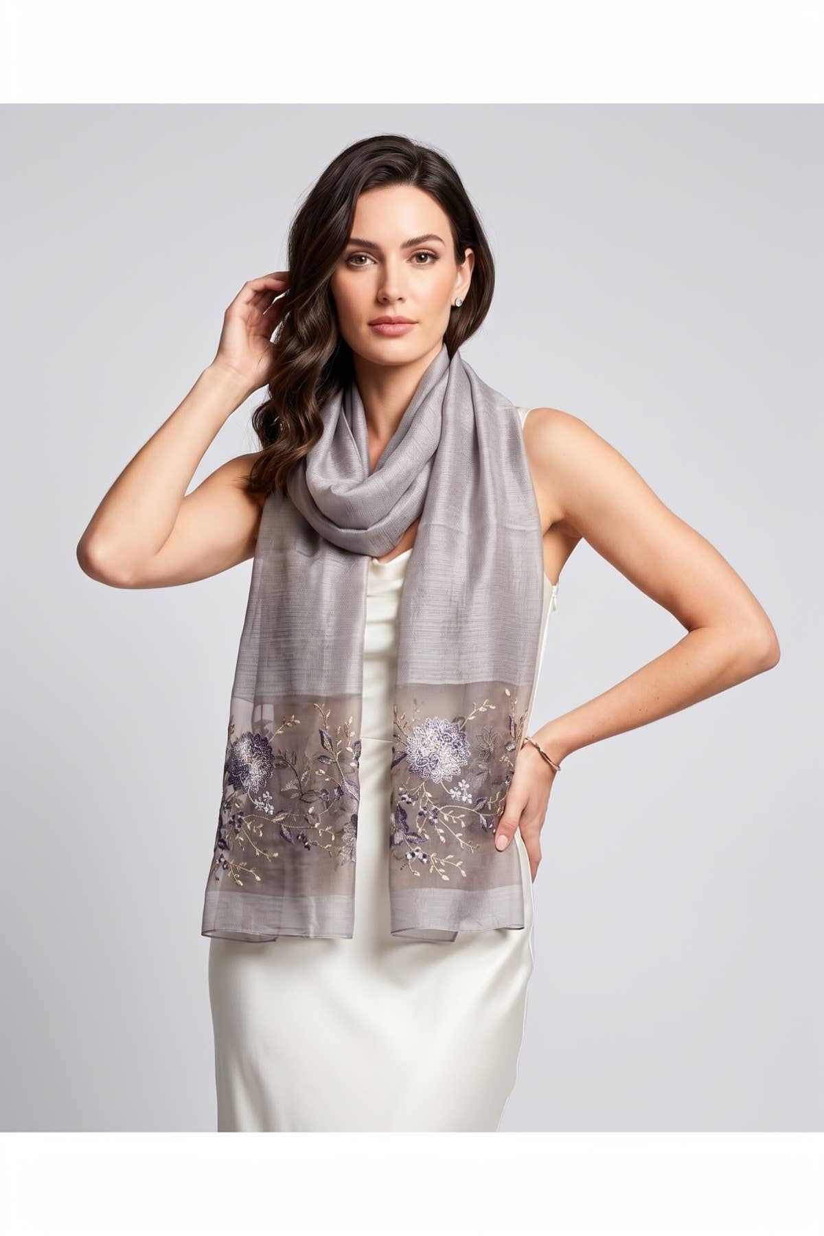 Grey floral embroidered sheer scarf worn over the shoulders