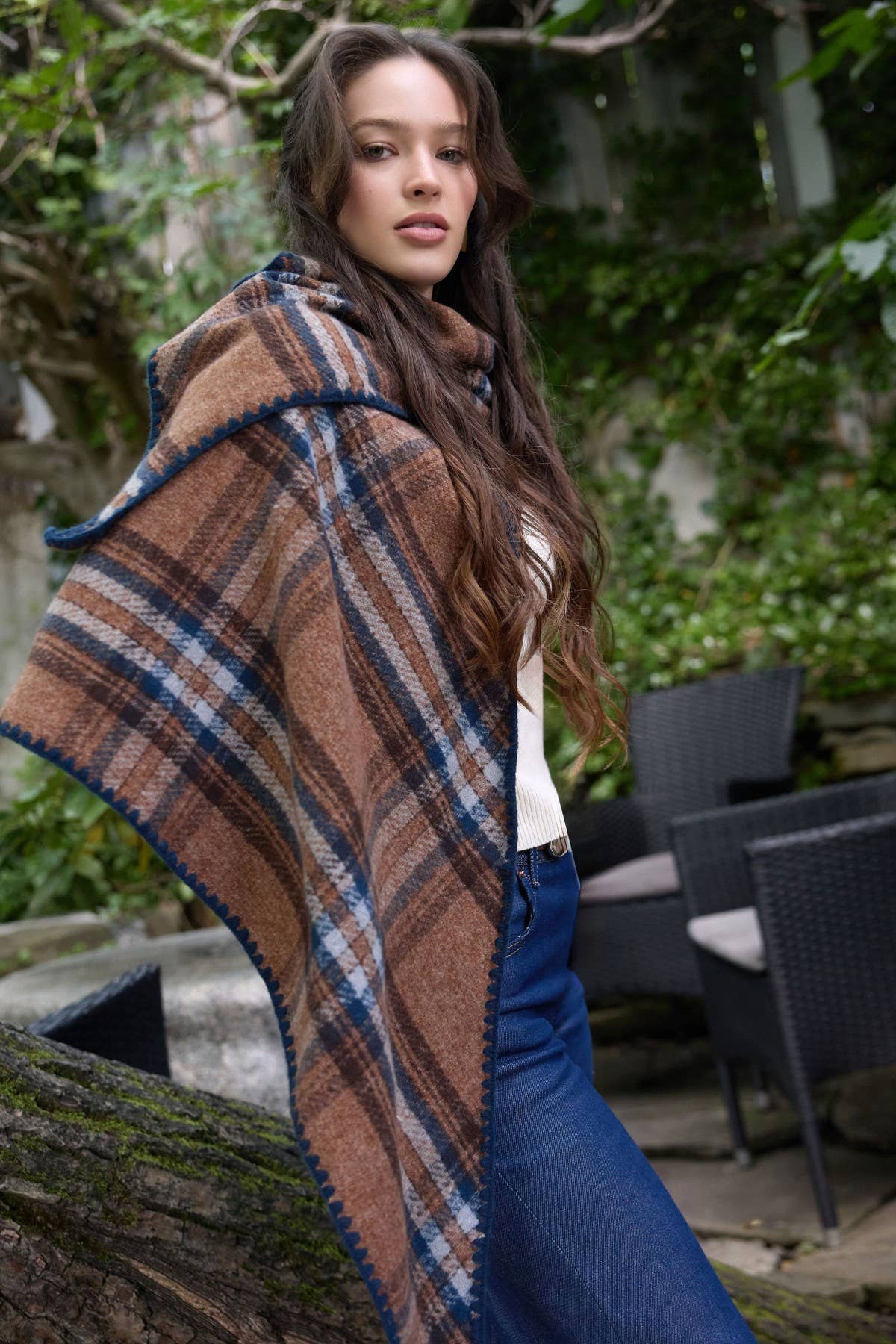 Brown plaid knitted triangle shawl worn over the shoulders