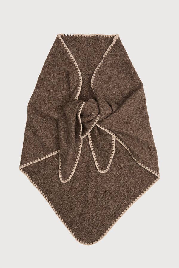 Woman wearing the taupe knitted triangle shawl
