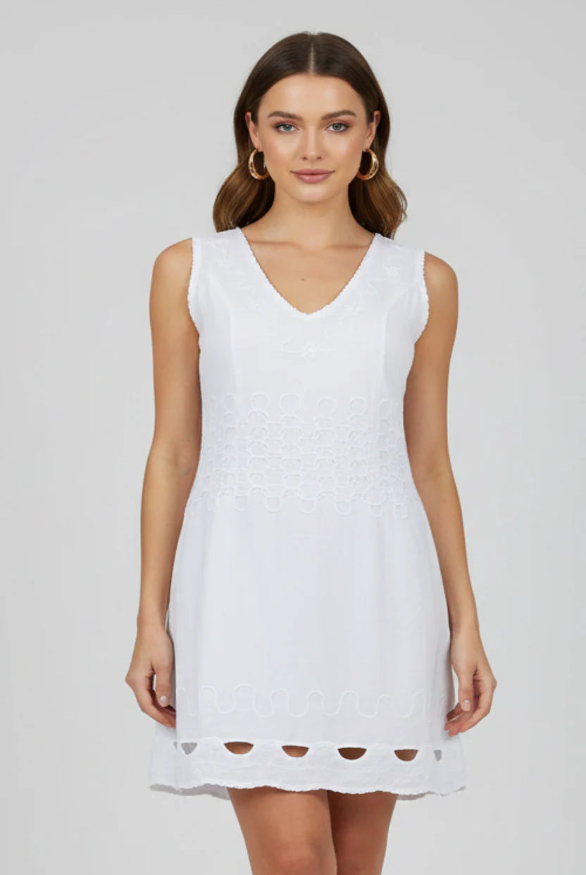 Woman wearing a white sleeveless dress on a plain background