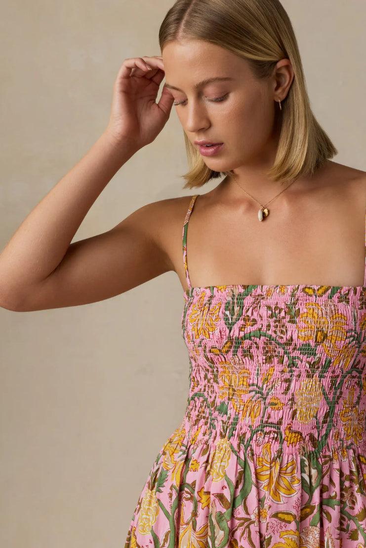 Woman wearing a floral dress with a neutral background