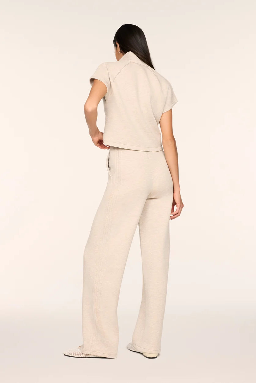 Full-length back view of the Spanx AirEssentials Pintuck Half Zip Jumpsuit in Bone Heather showing the stand collar, short sleeves, side pocket and relaxed wide-leg fit
