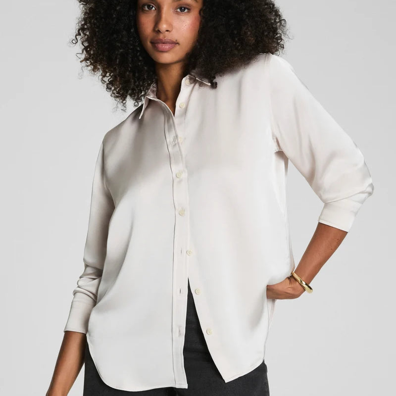 SPANX Silky Smooth Button Down in Birch soft ivory with black pants, relaxed-yet-tailored fit, front view