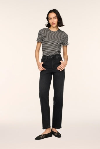Woman wearing SPANXshape Authentic 360 90s Straight Leg Jeans in Deep Space washed black denim, high rise with a straight ankle-length leg, styled with a striped tee and black woven flats