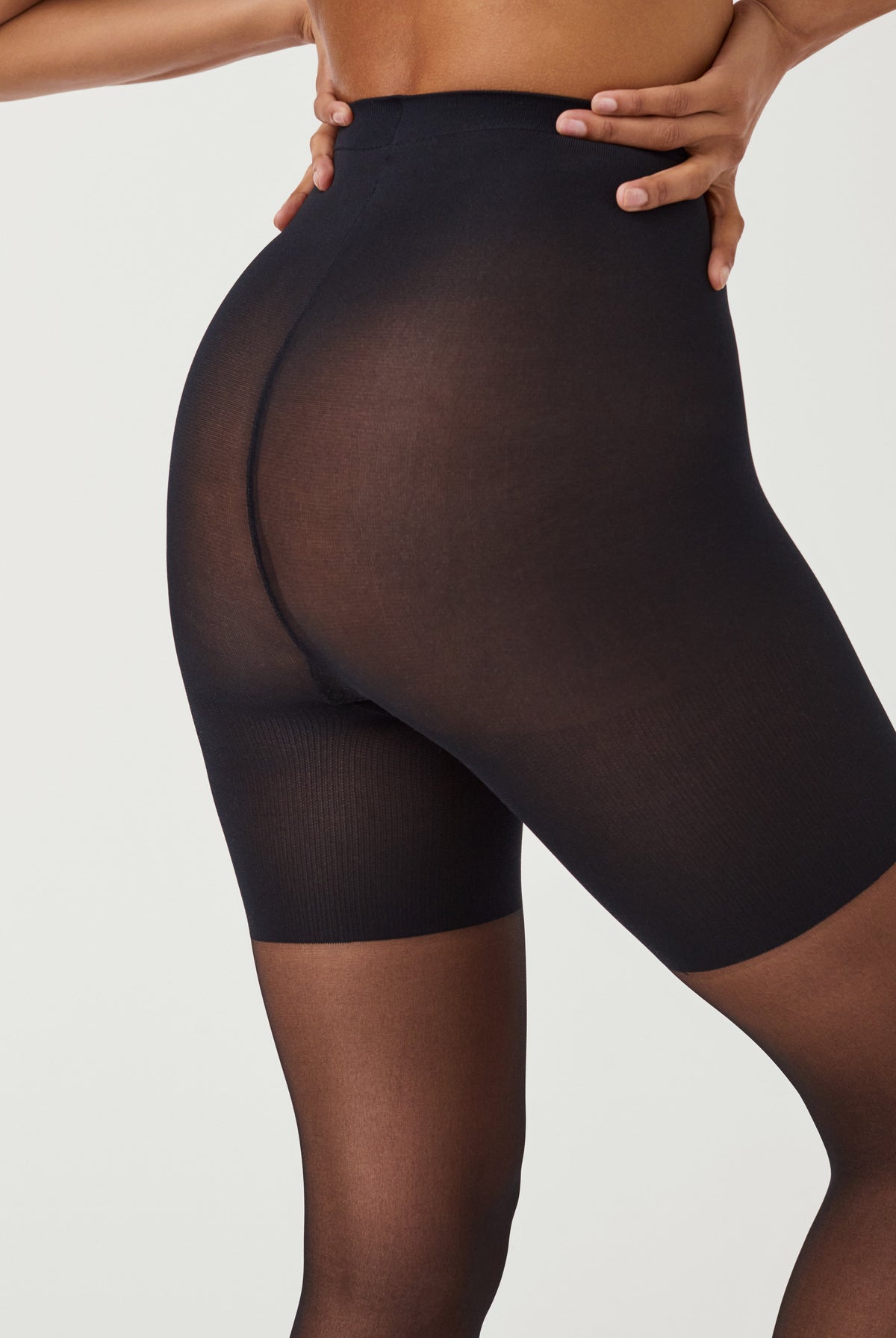SPANXshape Original Footless Sheers in Black, back view showing smoothing through the seat and thighs