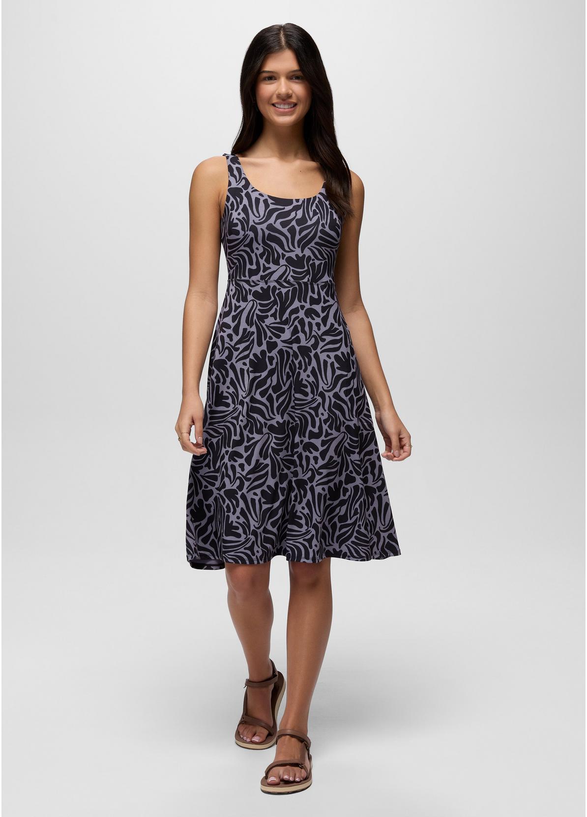 Woman wearing a patterned dress on a white background