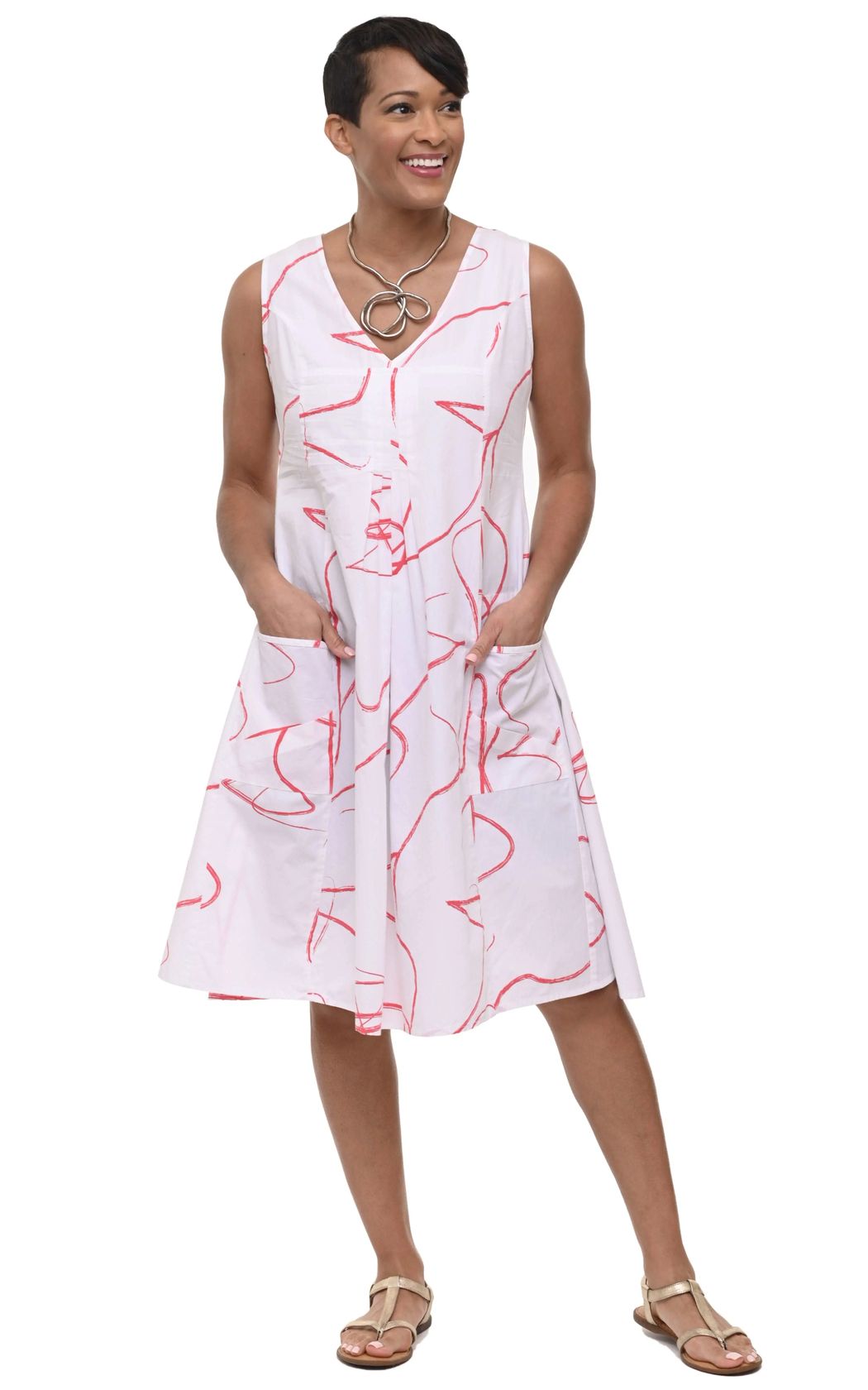 Tulip Clothing Women's Poppie Dress in Dabba, woman wearing a white sleeveless midi dress with an abstract red line print, paired with beige sandals, on a white background