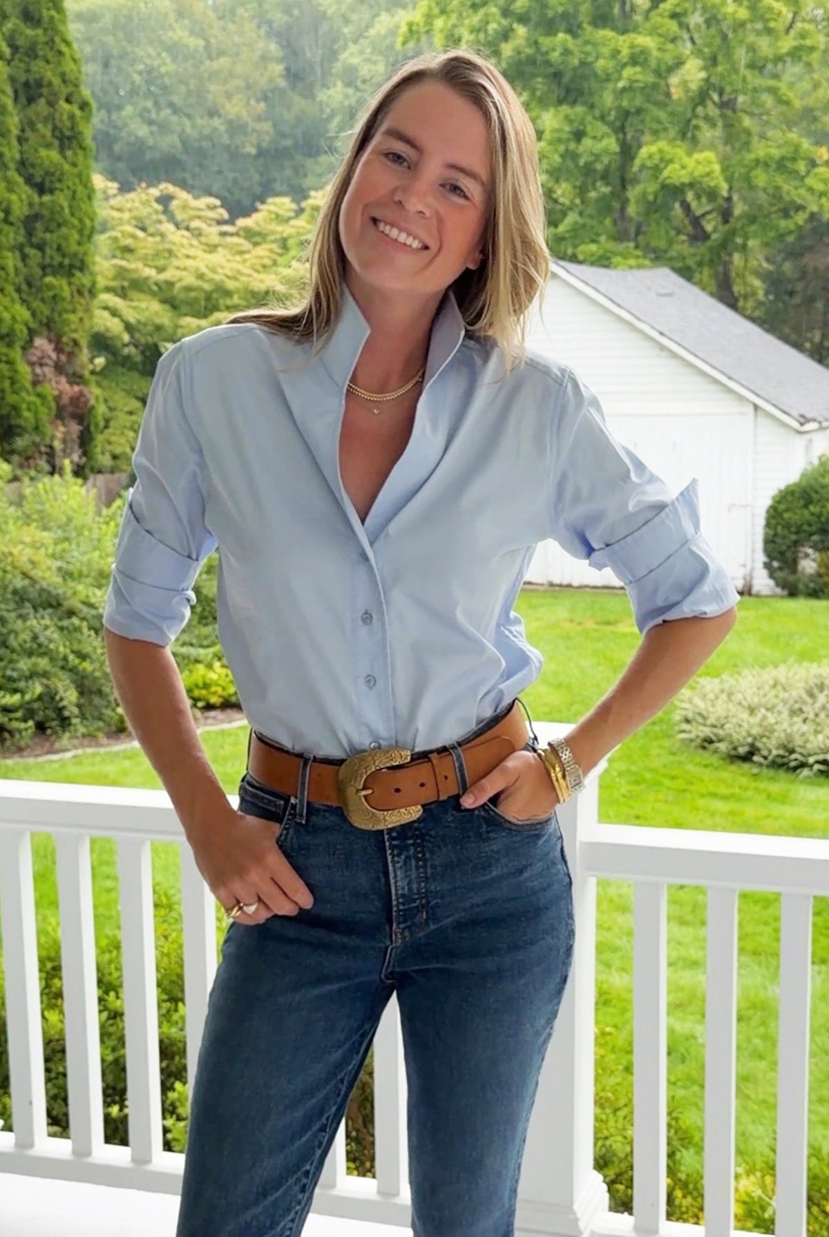 Tyler Böe Natalie Sateen Shirt in Blue worn with jeans and a belt outdoors