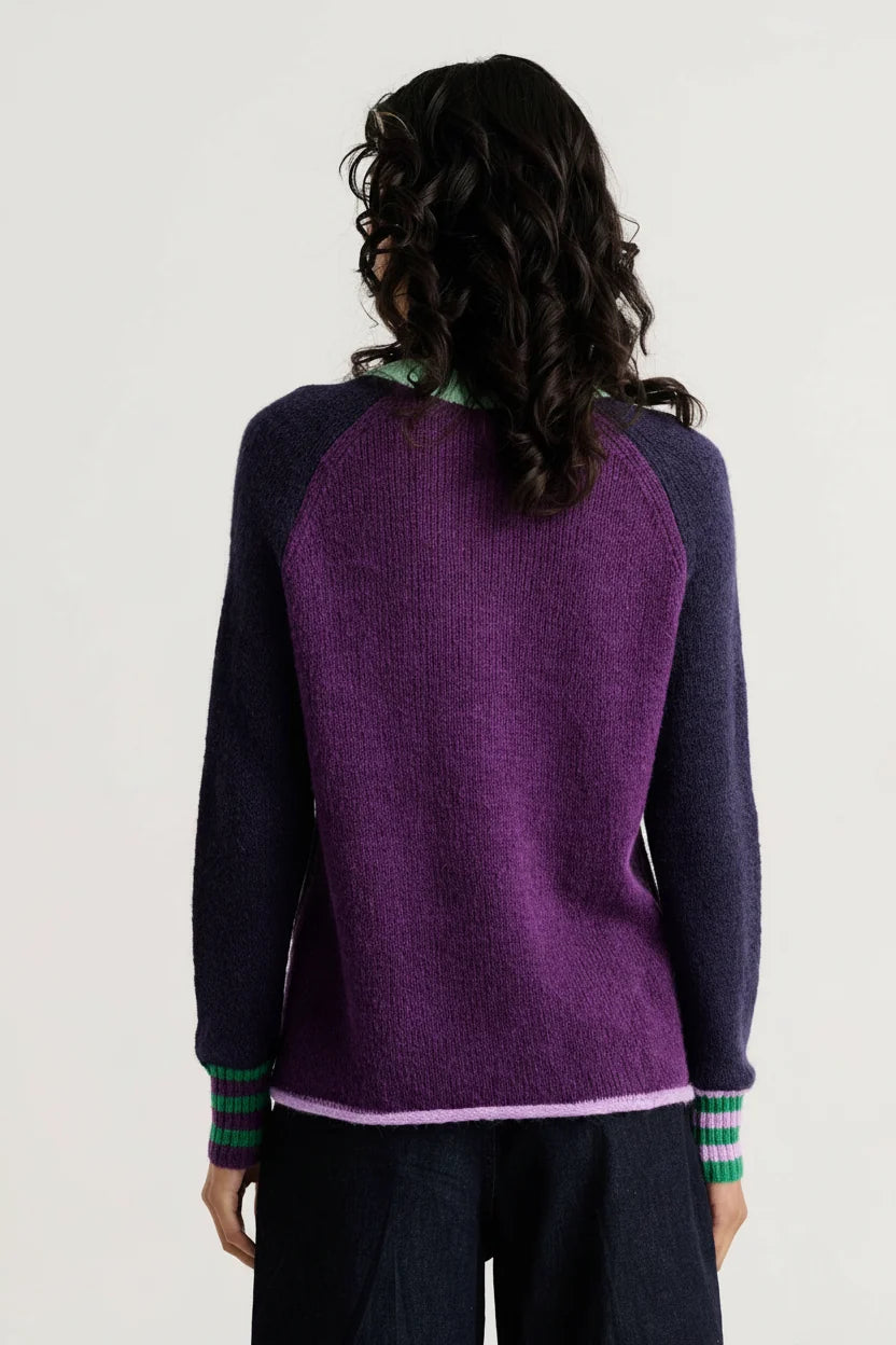 Back view of the Zaket & Plover Studio Pop Sweater in Navy with a purple back panel, navy raglan sleeves and striped cuffs